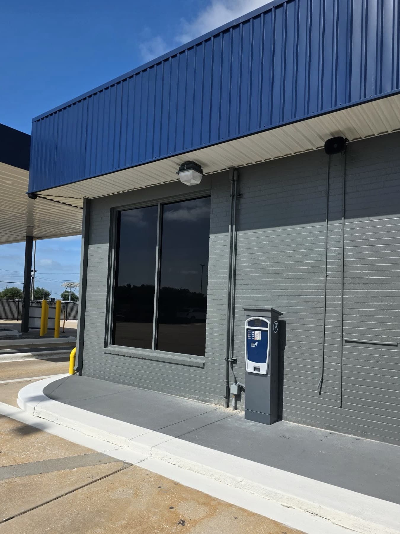 Self-serve payment kiosk mounted on the booth wall at Hobby Airport Parking
